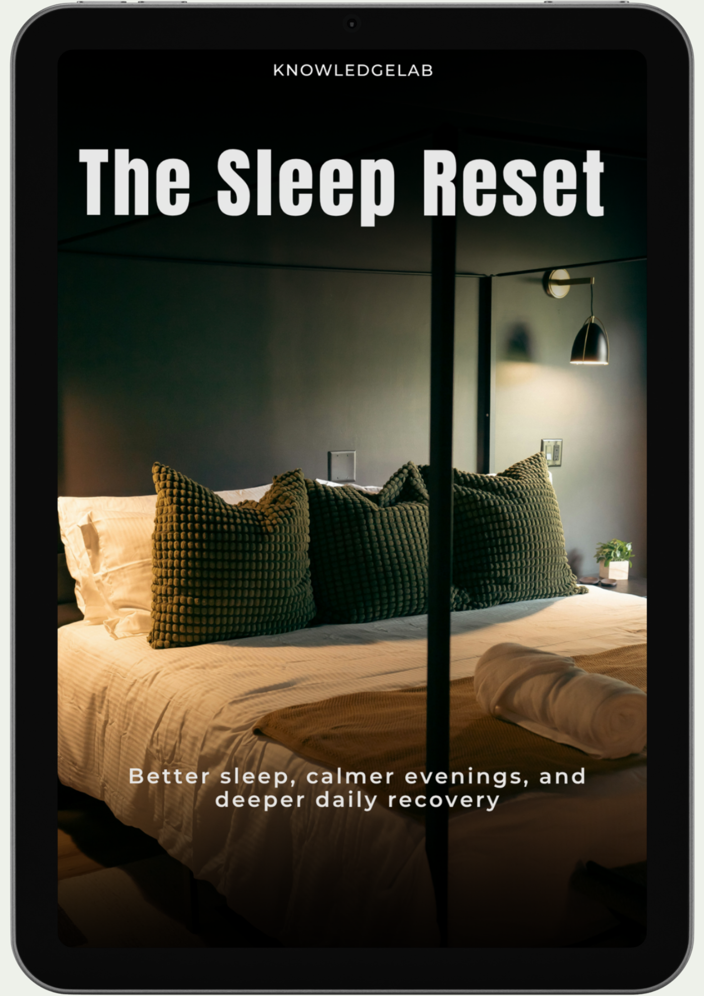 A tablet shows The Sleep Reset ebook cover featuring a cozy bed with green pillows in a softly lit bedroom. Text reads: Better sleep, calmer evenings, and restorative rest through soothing evening routines.